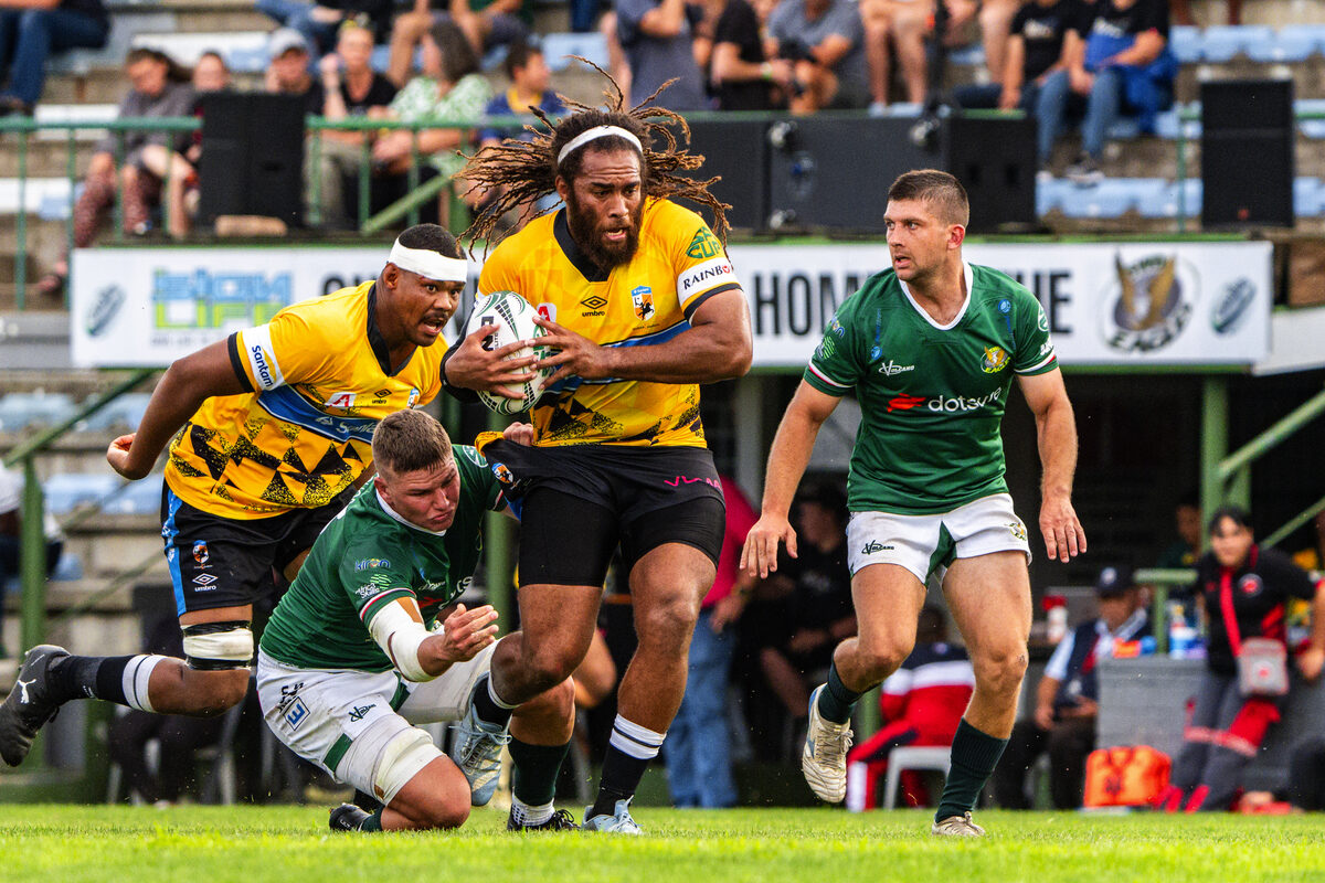 Auliegh Arendse van die Boland Kavaliers word gelak deur die SWD Arende se Gideon van Wyk. Marlyn Williams (Kavaliers) en Tiaan Fourie (regs) is reg om te ondersteun.